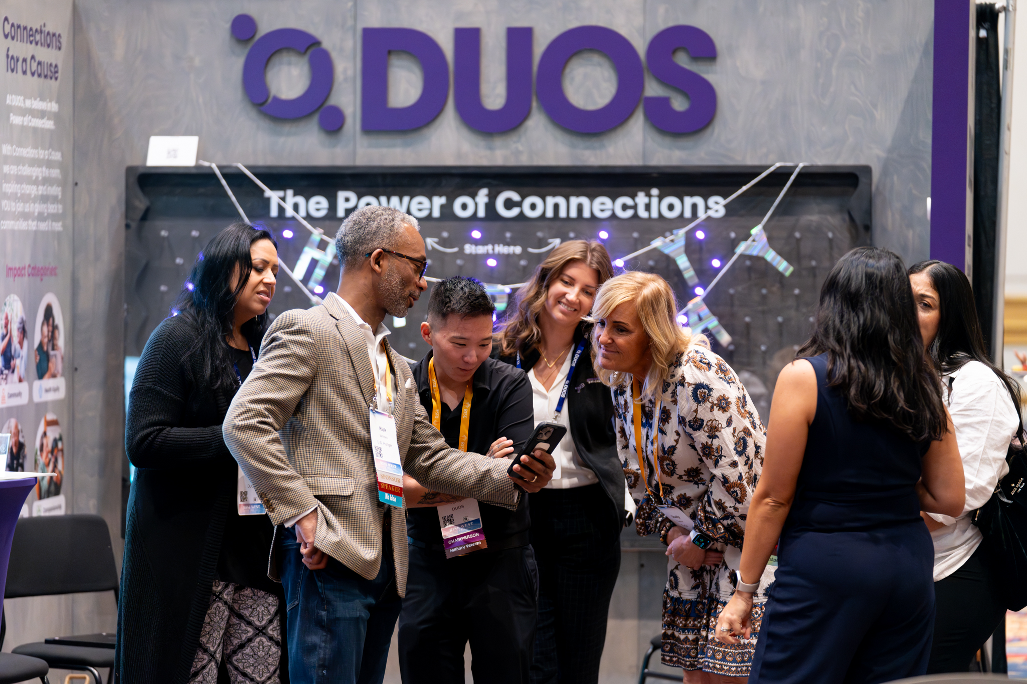 A group of attendees speaking in the exhibit hall